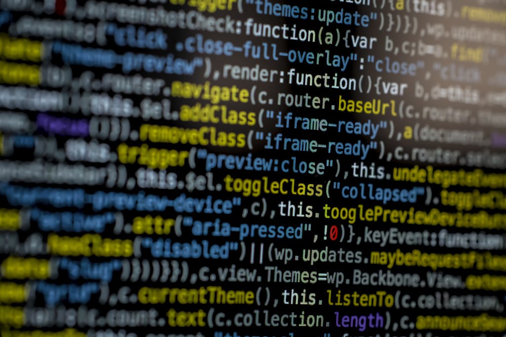 An extreme close-up of colorful programming code on a computer screen, showcasing development and software debugging.